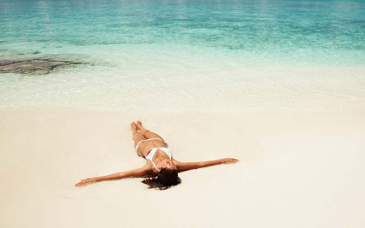 Woman Laying on Beach